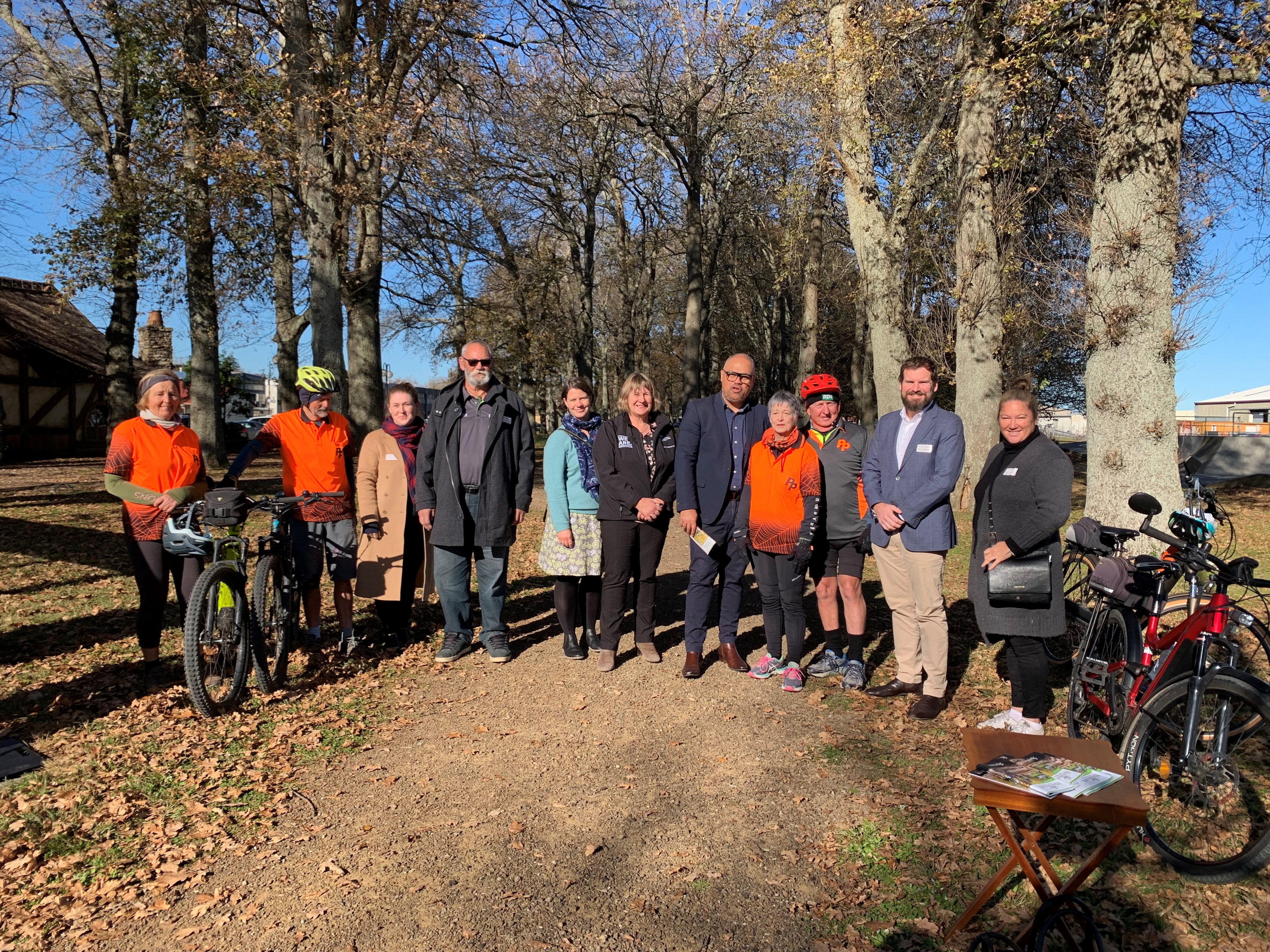 Members from the Piako Peddlers; HRT Charitable Trust Board; local government and the Mayor of Matamata-Piako stand with Tourism Minister Peeni Henare and MP for Waikato Tim van der Molen at the Hauraki Rail Trail in Matamata