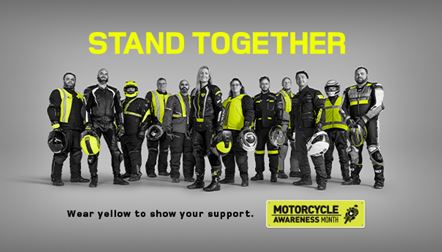Stand Together in Yellow - lineup of motorbike riders wearing high viz yellow highlights